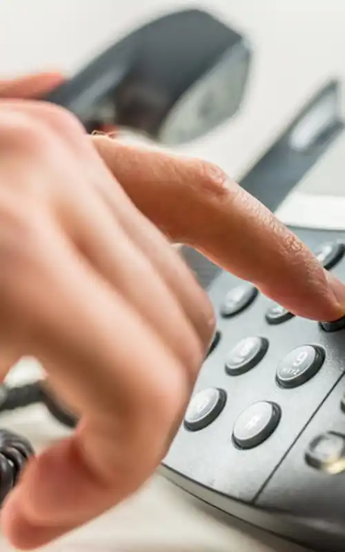 Man pushing button on office phone