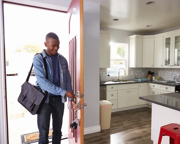 african american male walking through front door of house
