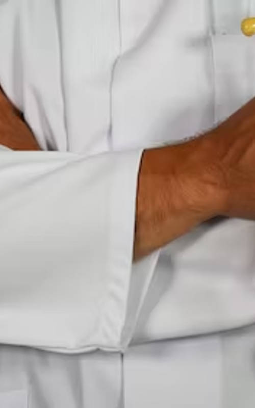 A doctor with crossed arms holding a stethoscope