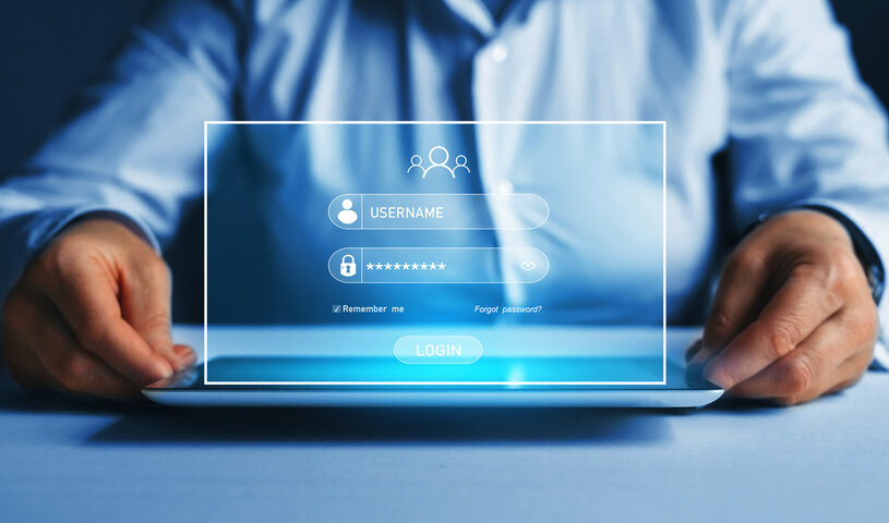 A man holding a laptop with his account shown