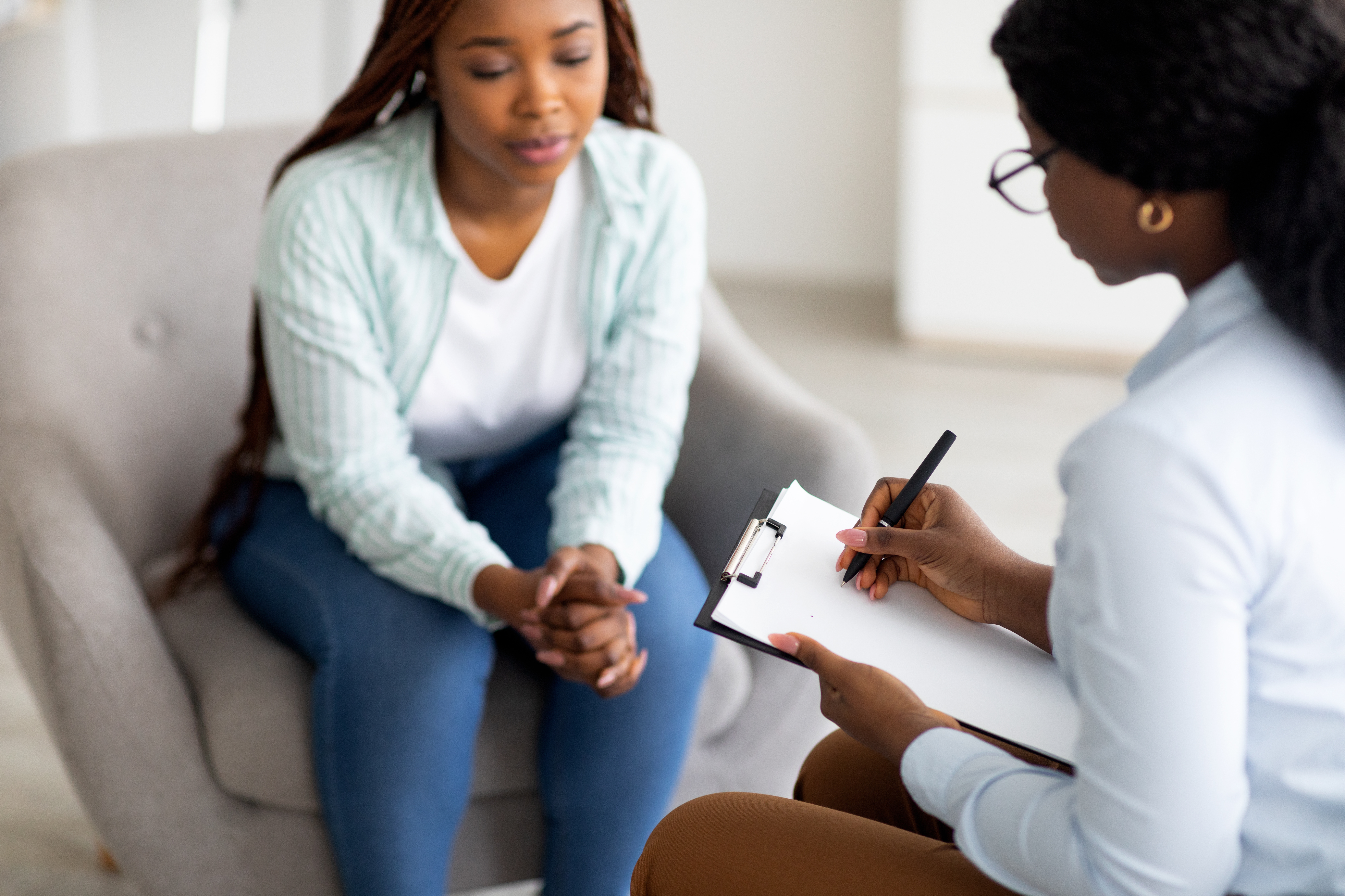 A personal counseling session between two women - one is a therapist and the other a patient