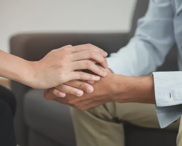 A person extending their hand in support to a person