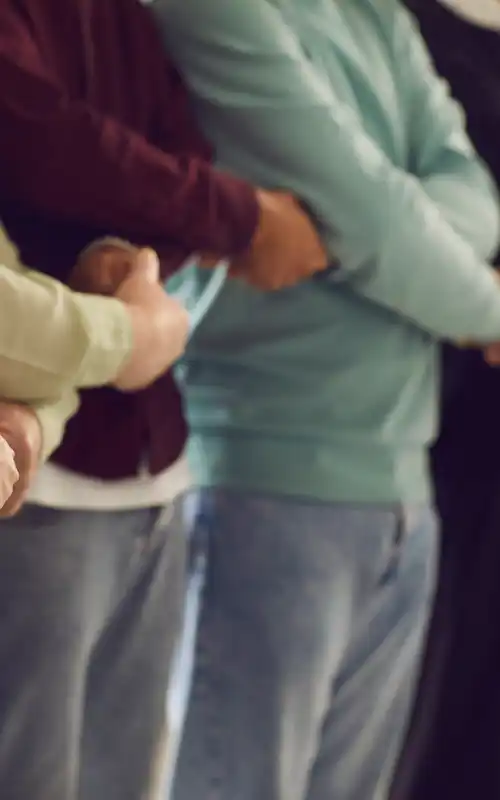 A group of people holding hands and standing together