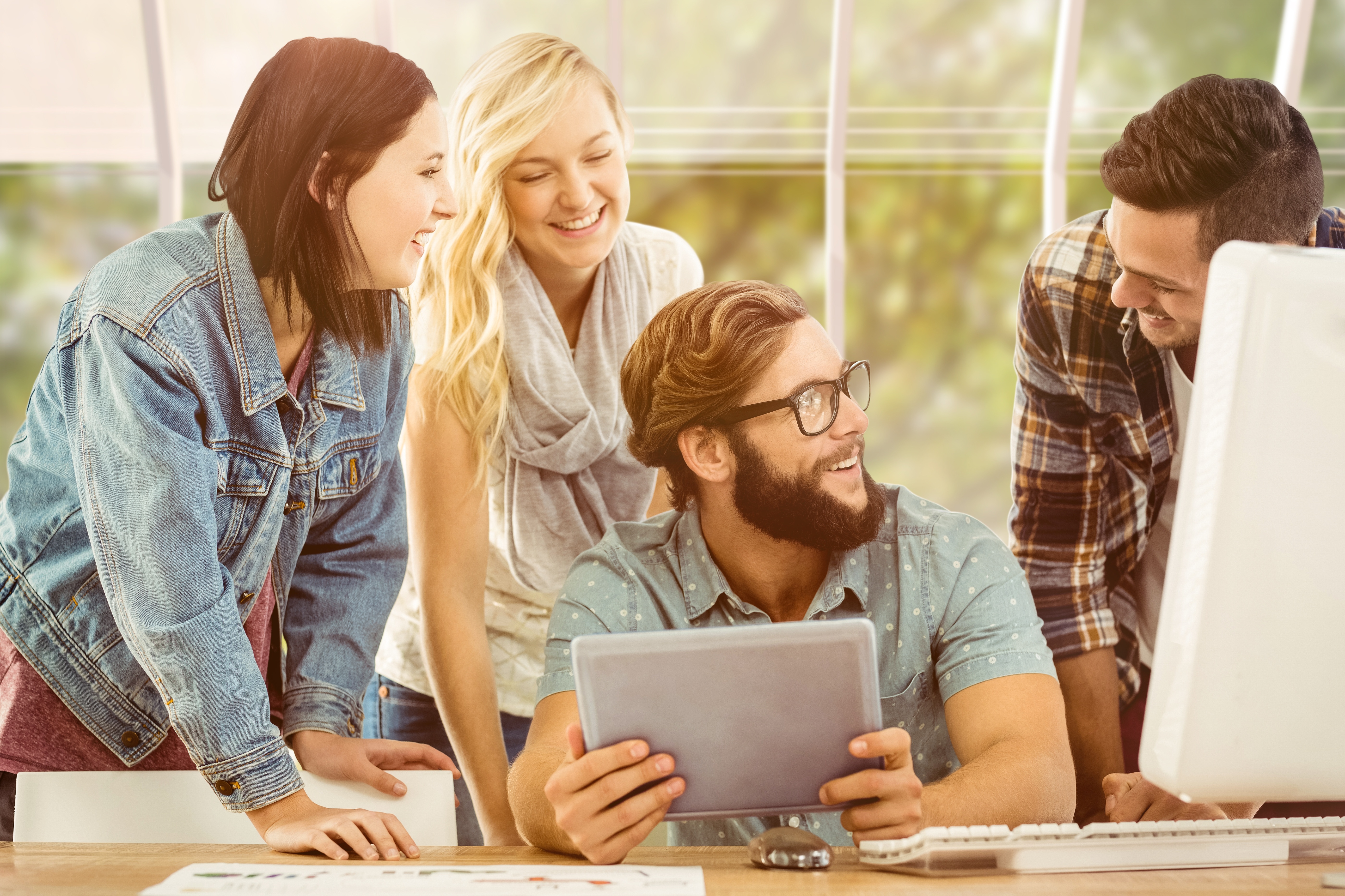 Three people around a man with a tablet asking questions