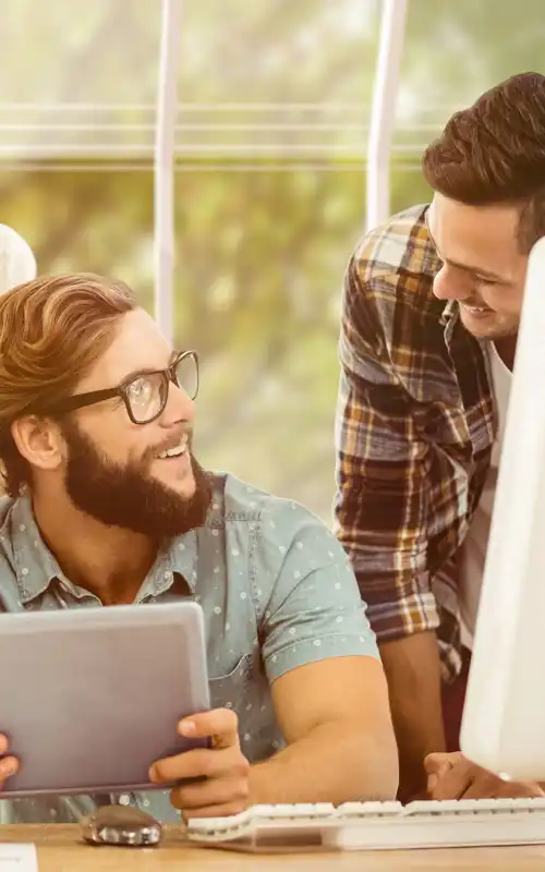 Three people around a man with a tablet asking questions
