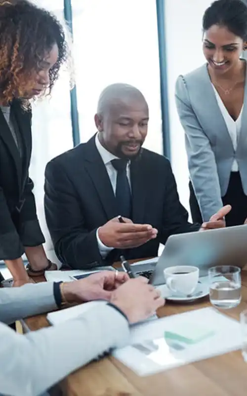 A group of diverse individuals sitting in a board room and elevating their career