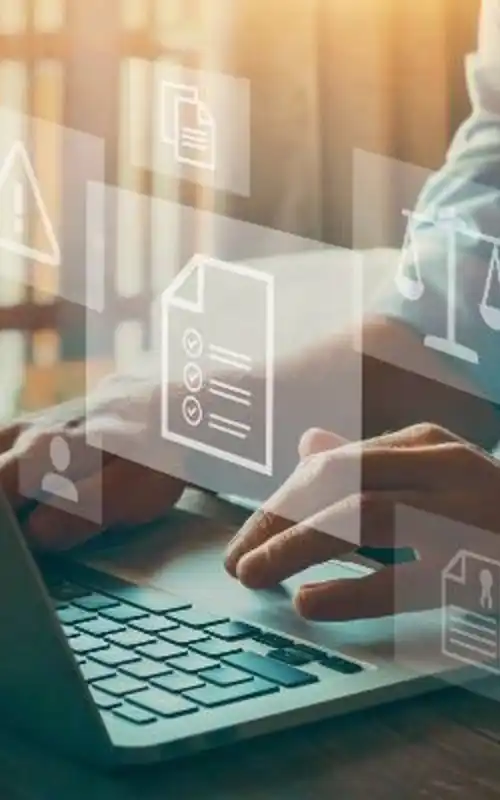 Compliance specialist typing on keyboard with projected icons