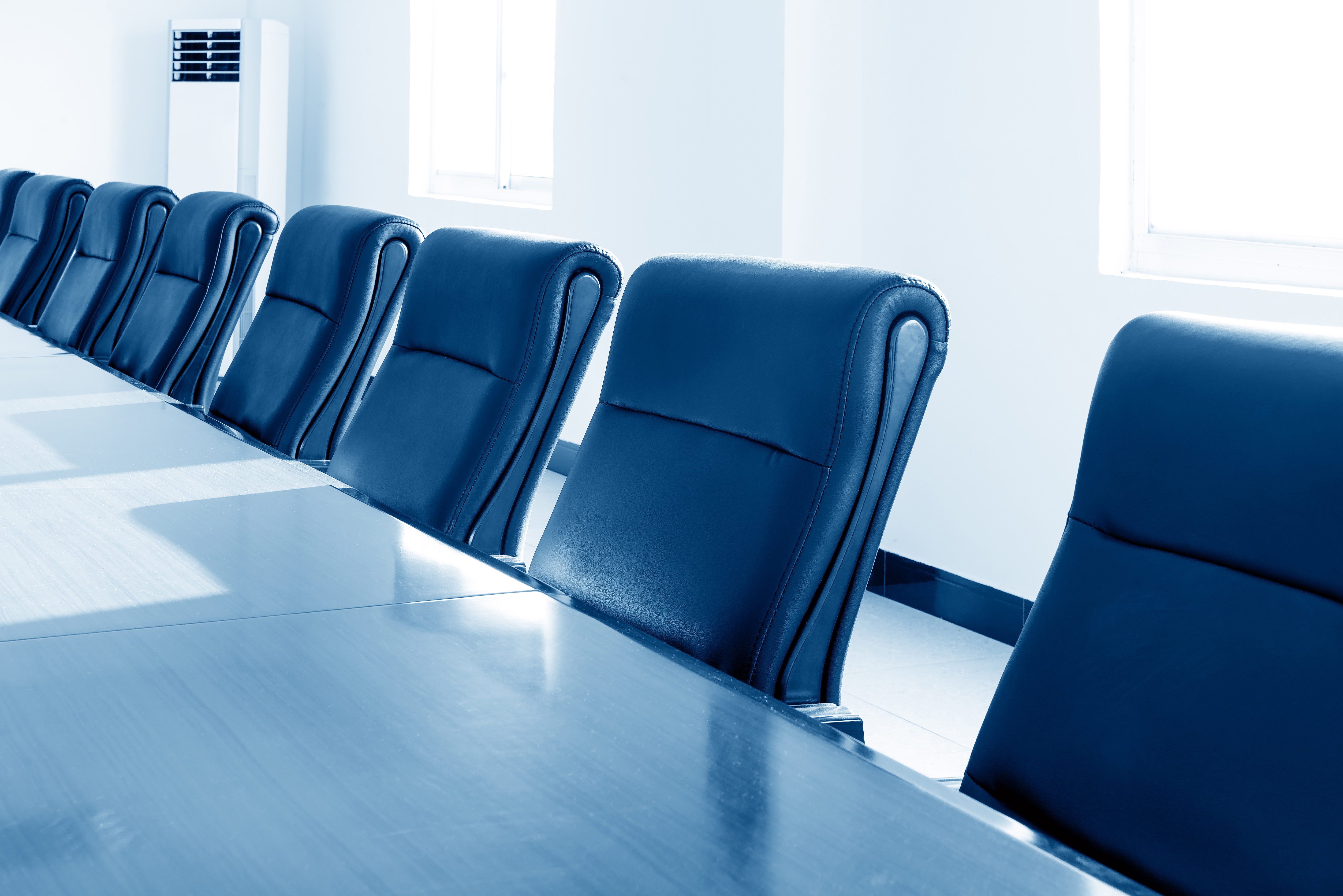 boards of director meeting room with empty chairs